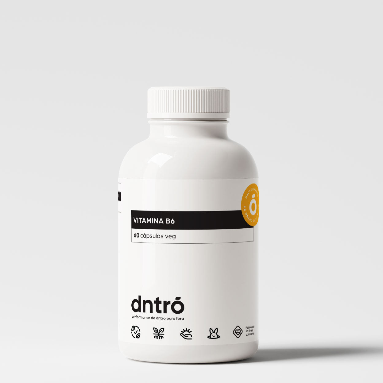Frasco do suplemento DNTRO Vitamina B6 com 60 cápsulas veganas. Embalagem branca com design clean, selo laranja “Performance de dentro para fora”. Produto vegano, sem glúten, indicado para energia, metabolismo e suporte ao sistema nervoso.