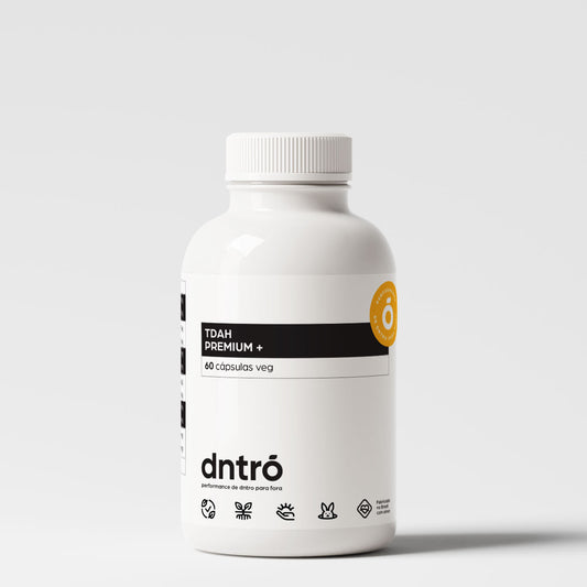 Frasco do suplemento DNTRO TDAH Premium+ com 60 cápsulas veganas. Embalagem branca minimalista com rótulo preto e selo laranja “Performance de dentro para fora”. Produto vegano, sem glúten, formulado para foco, clareza mental e produtividade.
