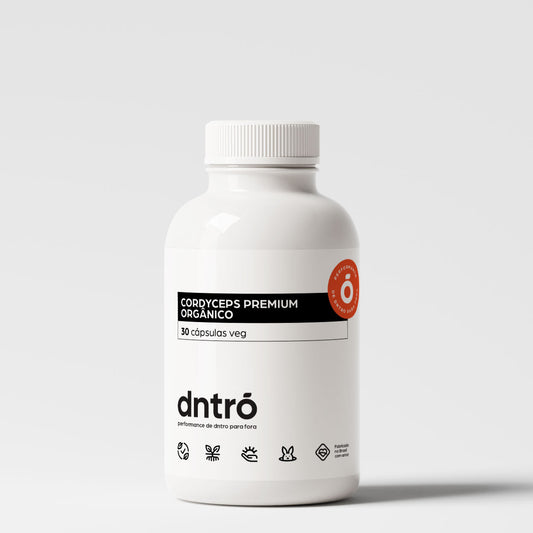 Frasco do suplemento Cordyceps Premium Orgânico da Dntró com 30 cápsulas veganas. Produto natural para energia e vitalidade, com embalagem branca minimalista, selo de pureza e ícones de produto vegano, sem glúten, sem lactose e não testado em animais.