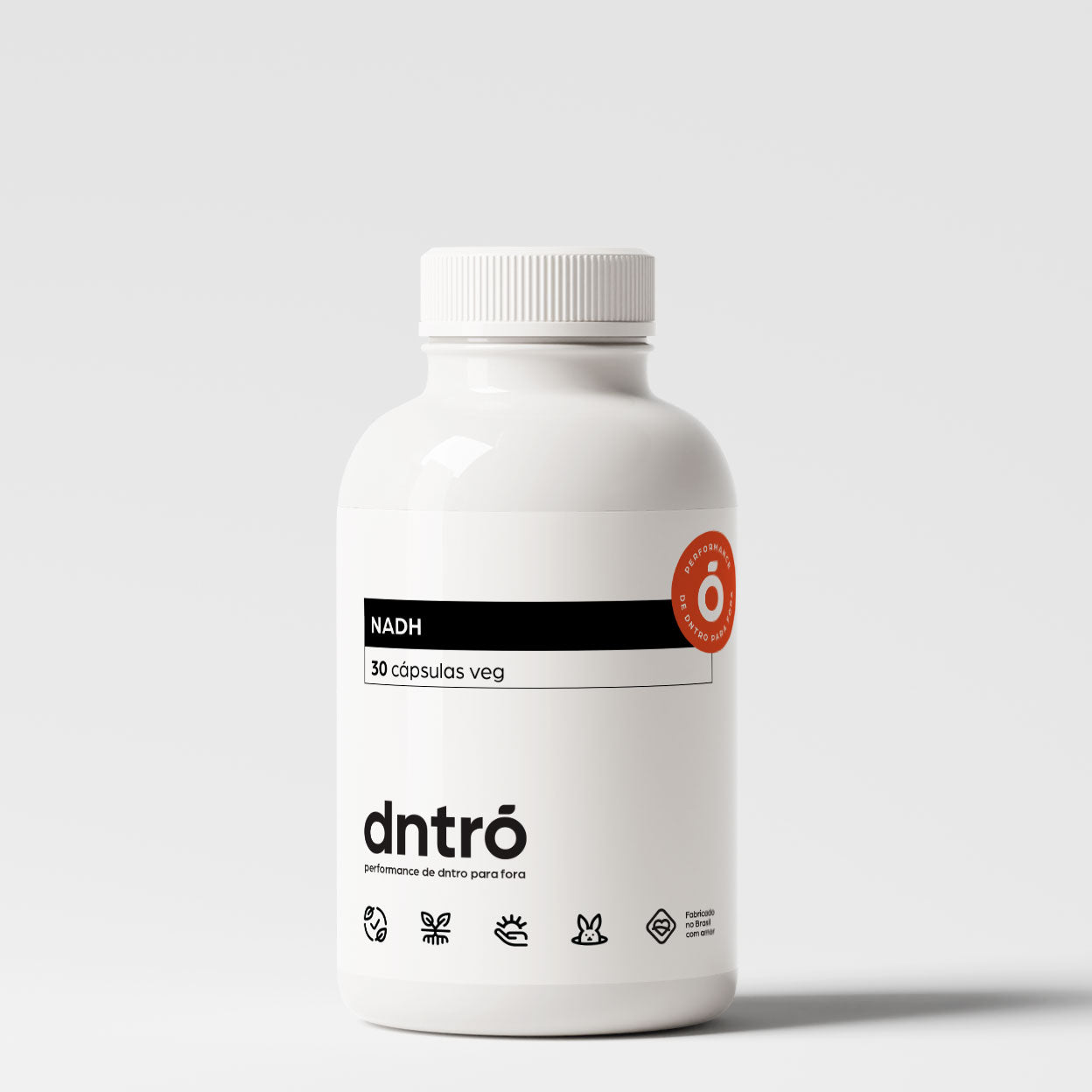 Frasco do suplemento NADH Dntró com 30 cápsulas veganas. Produto vegano, sem glúten, sem lactose e não testado em animais. Embalagem minimalista branca com selo de pureza e ícones de qualidade. Ideal para suporte energético e desempenho cognitivo.